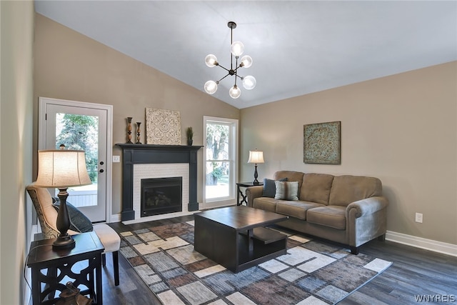 living room featuring a chandelier, hardwood / wood-style floors, high vaulted ceiling, and a healthy amount of sunlight