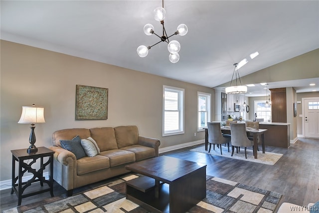 living room with dark hardwood / wood-style flooring, lofted ceiling, and a notable chandelier