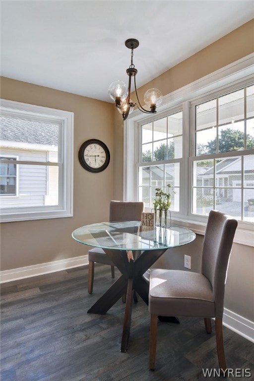 dining area featuring a notable chandelier and dark hardwood / wood-style flooring