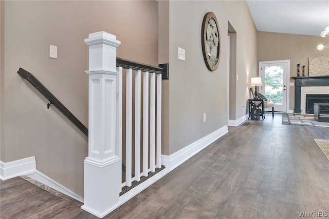 stairs with hardwood / wood-style flooring, ornate columns, and a high ceiling