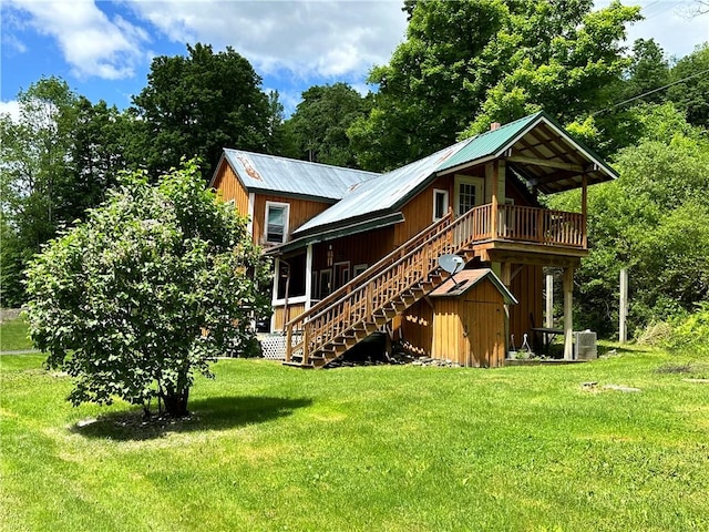 back of house with a lawn