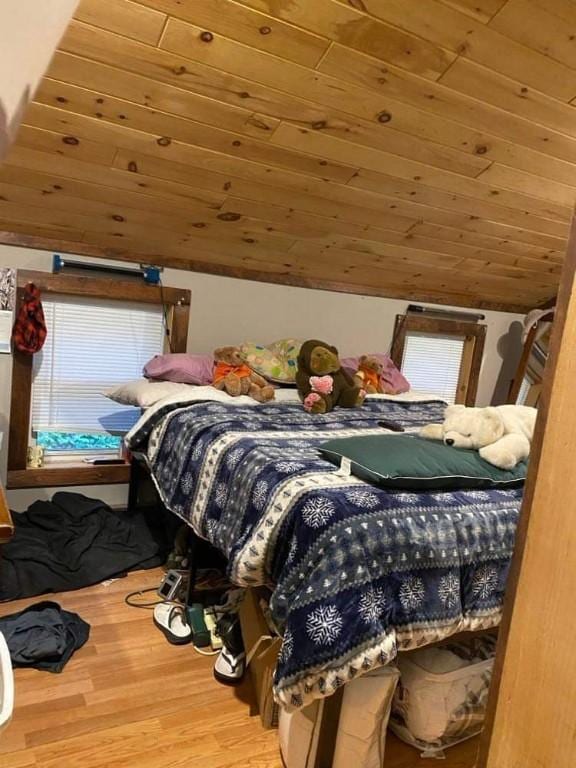 bedroom featuring hardwood / wood-style floors, wooden ceiling, and vaulted ceiling