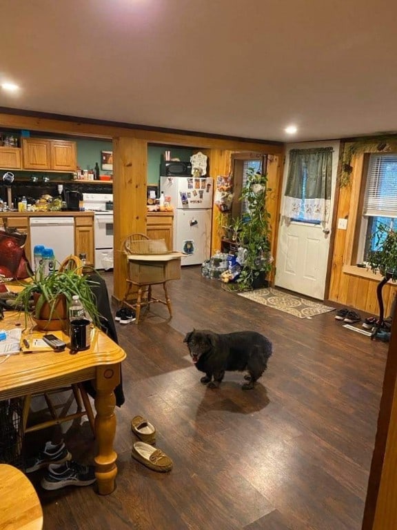 dining space featuring dark hardwood / wood-style floors and wooden walls