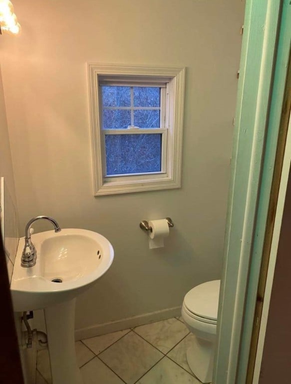 bathroom with toilet and tile patterned floors