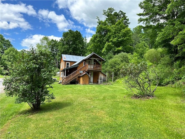 rear view of property with a lawn and a deck