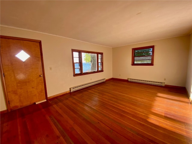 foyer featuring crown molding, a baseboard heating unit, and wood-type flooring