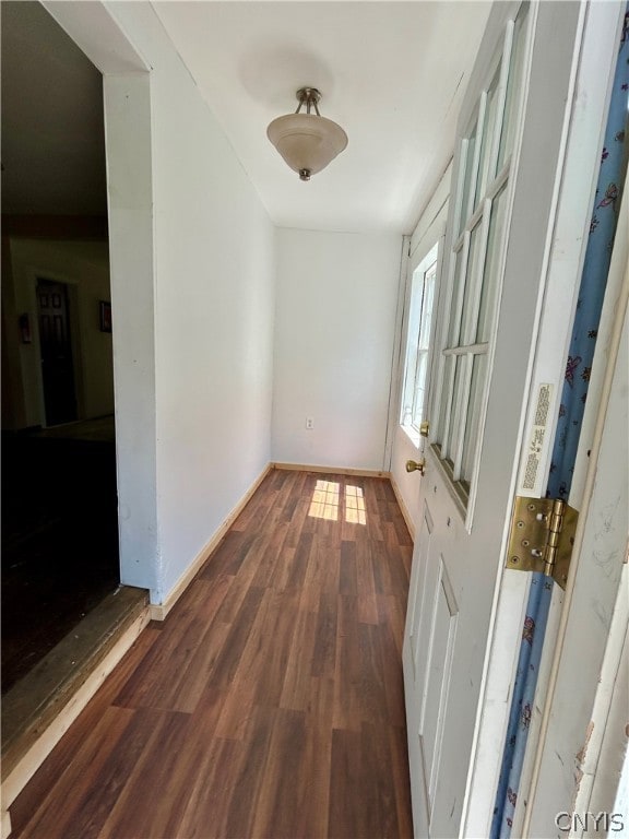 hallway with hardwood / wood-style floors