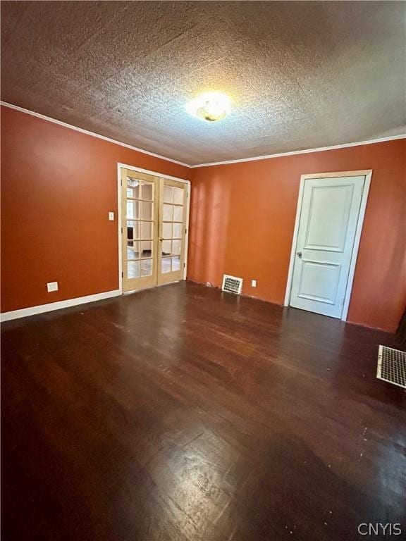 919 Lenox Ave, Utica, NY 13502 - empty room with visible vents, ornamental molding, a textured ceiling, wood finished floors, and french doors