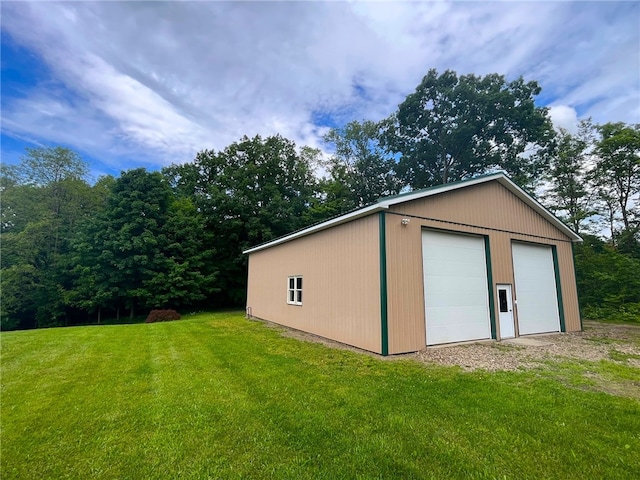 view of outbuilding with a lawn and a garage