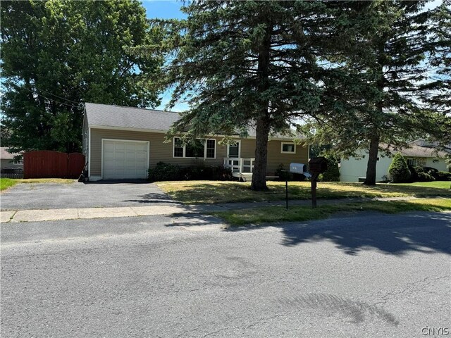 view of front of property featuring a garage and a front yard