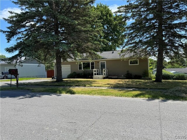 view of front of house with a garage and a front yard