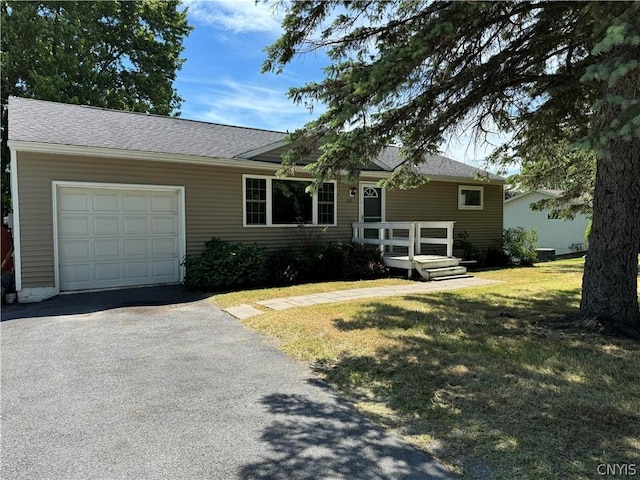 ranch-style home with a garage and a front yard