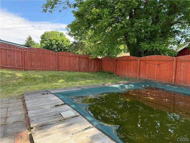 view of pool featuring a lawn