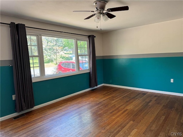 spare room with hardwood / wood-style flooring and ceiling fan