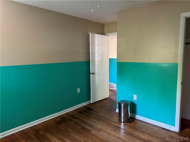 spare room featuring dark hardwood / wood-style floors