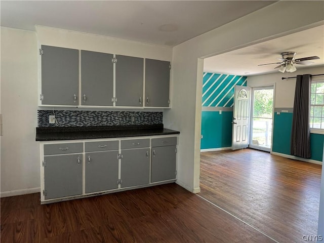 kitchen featuring gray cabinets, tasteful backsplash, dark wood-type flooring, and ceiling fan