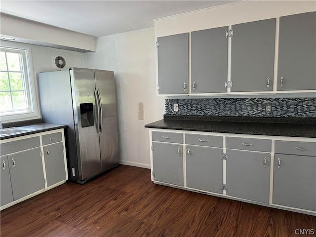 kitchen featuring gray cabinets, dark hardwood / wood-style floors, tasteful backsplash, sink, and stainless steel refrigerator with ice dispenser