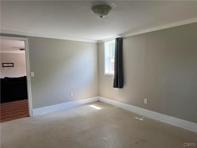 unfurnished room with ornamental molding and concrete floors