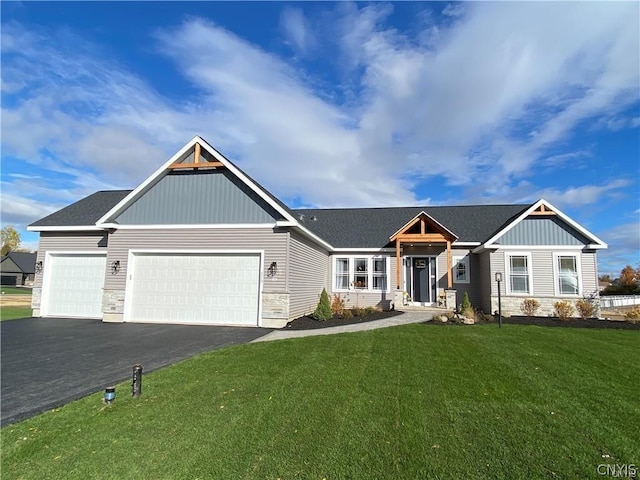 craftsman house with a front yard and a garage