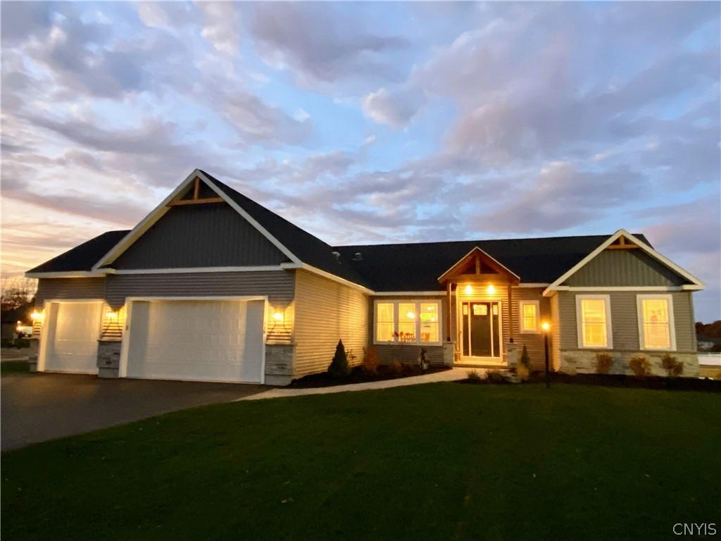 view of front of home with a yard and a garage