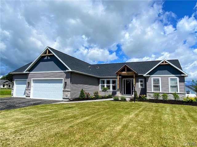 craftsman-style home with a front yard and a garage