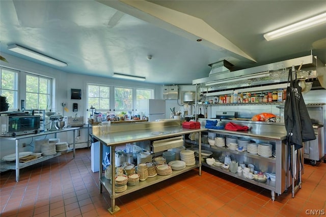 kitchen with tile patterned flooring and lofted ceiling