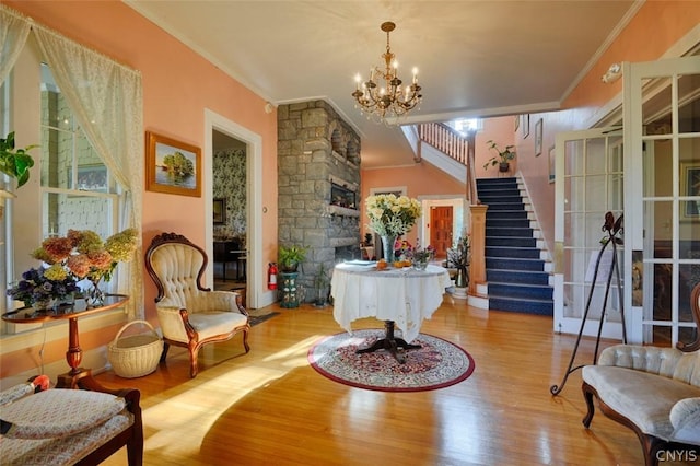 interior space with ornamental molding, a chandelier, and light hardwood / wood-style flooring