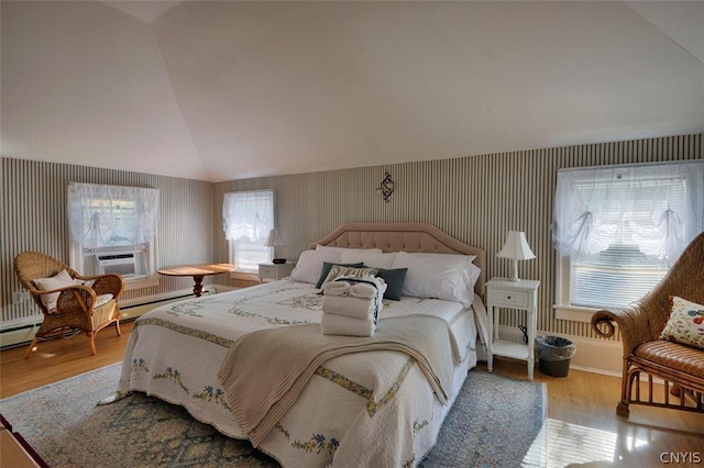 bedroom with vaulted ceiling, cooling unit, and light hardwood / wood-style floors