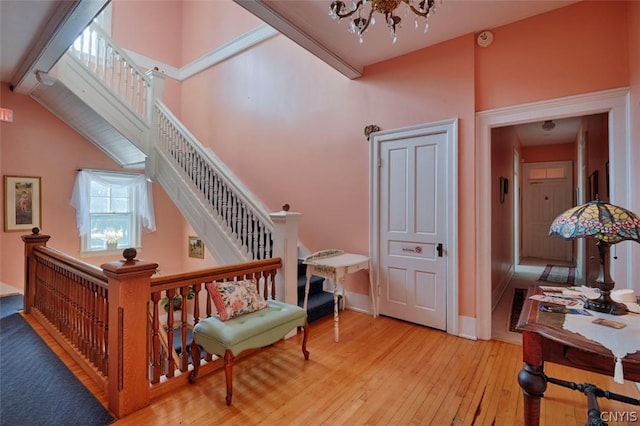 staircase with hardwood / wood-style flooring and a chandelier