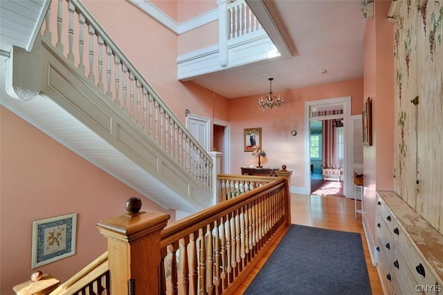 hall featuring a notable chandelier and light wood-type flooring