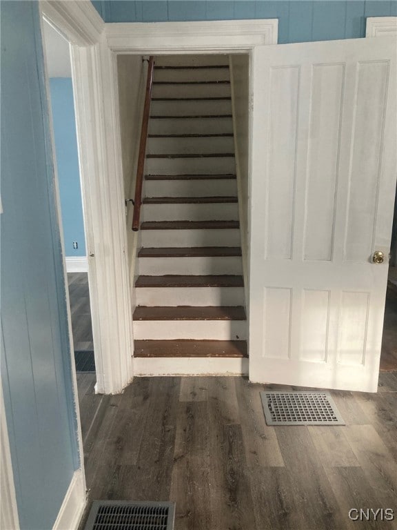 stairway with hardwood / wood-style flooring