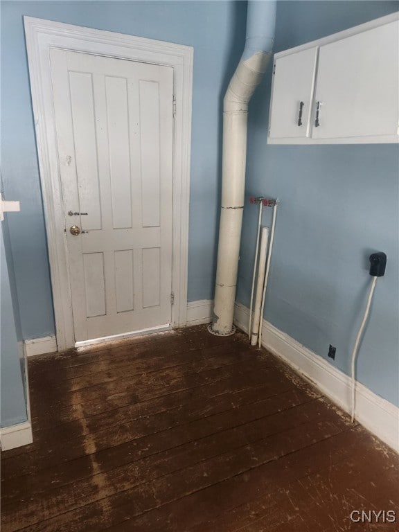 laundry room with dark hardwood / wood-style flooring, cabinets, and electric dryer hookup