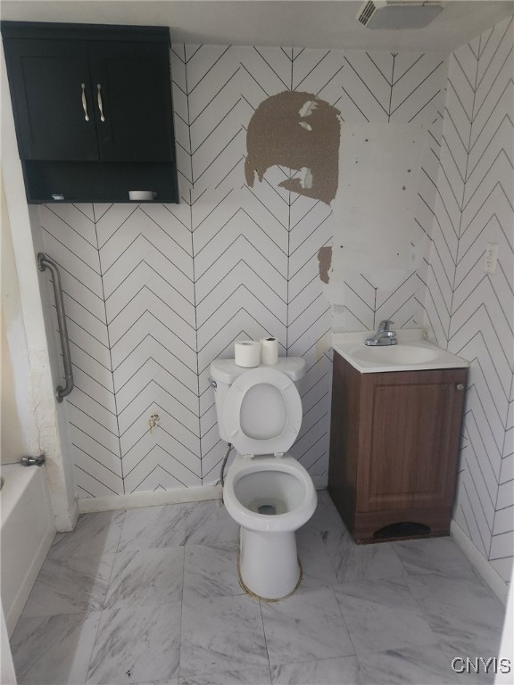 bathroom featuring toilet and vanity