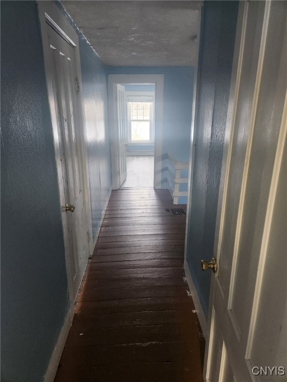 corridor with dark hardwood / wood-style floors