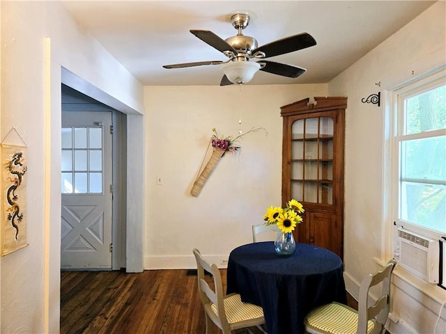 dining room featuring ceiling fan, cooling unit, and dark hardwood / wood-style flooring