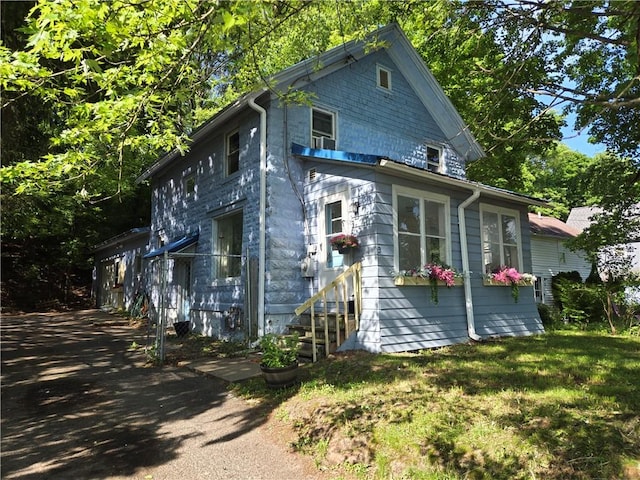 view of side of home featuring a yard