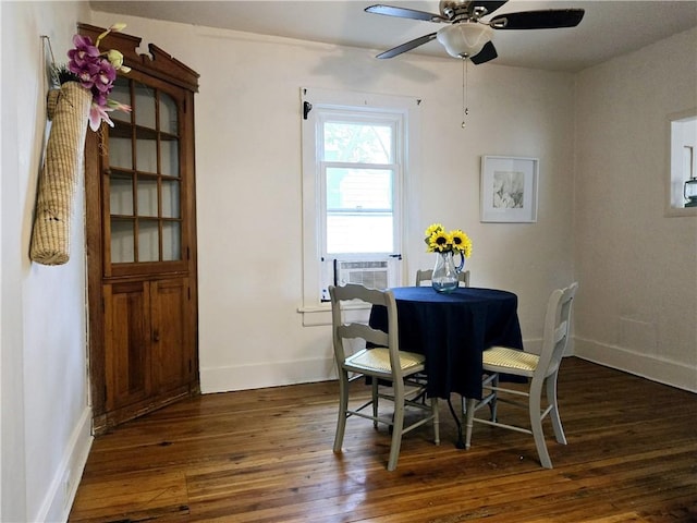 dining area with dark wood-type flooring, cooling unit, and ceiling fan