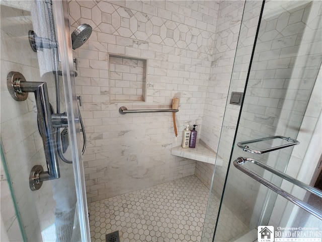 bathroom featuring a shower with shower door