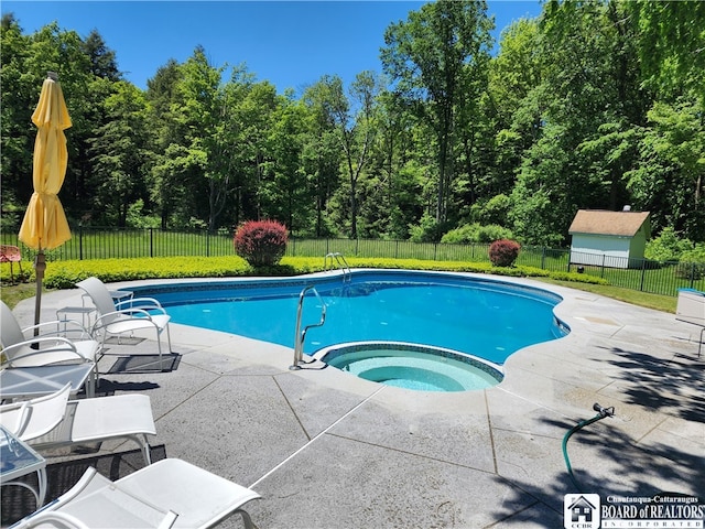 view of swimming pool featuring an in ground hot tub and a patio area