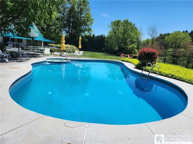 view of swimming pool featuring a yard, an in ground hot tub, and a patio area