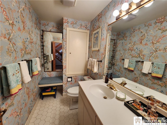 bathroom featuring vanity with extensive cabinet space, tile flooring, and toilet