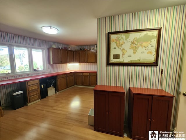 kitchen featuring built in desk and light wood-type flooring