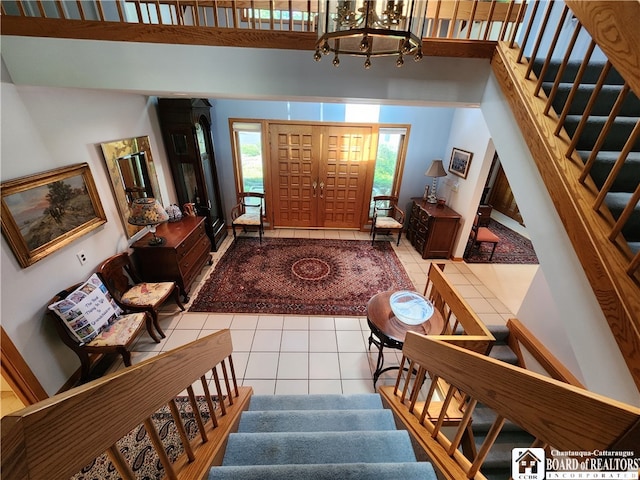 foyer featuring a notable chandelier and tile flooring