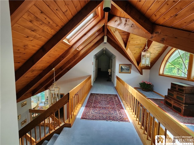 interior space with wooden ceiling, carpet, and lofted ceiling with skylight