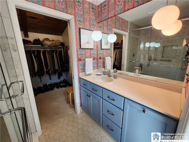 bathroom featuring walk in shower, tile flooring, and vanity with extensive cabinet space