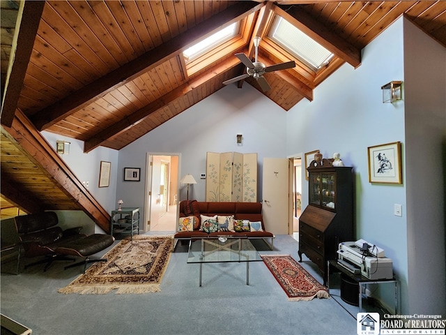 living room with carpet, beam ceiling, and a skylight