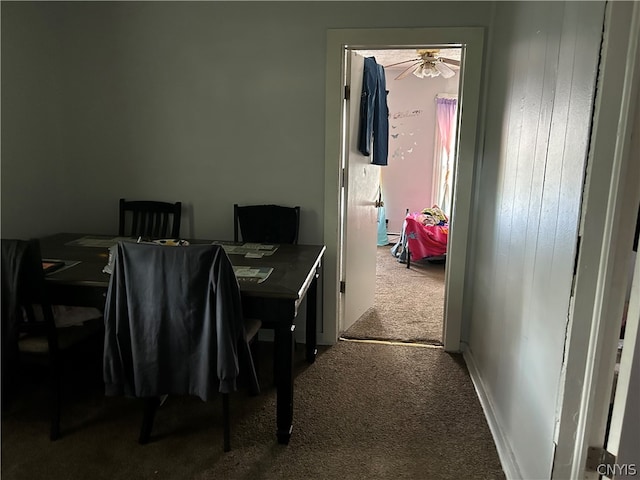 dining space with ceiling fan and carpet