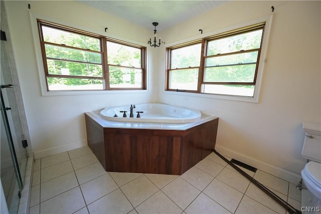 bathroom with tile patterned flooring, plenty of natural light, toilet, and a notable chandelier