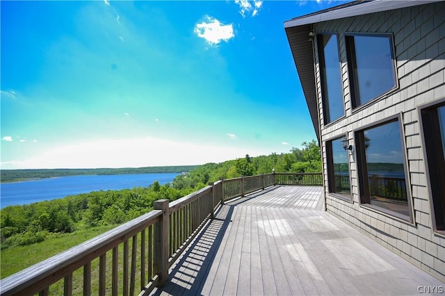 wooden terrace featuring a water view