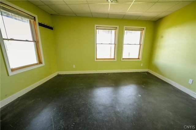 unfurnished room with a drop ceiling